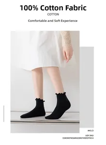 Detail of black cotton socks featuring ruffle hem design for stylish women footwear