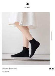 Detail of black crew socks with elegant ruffle trim edge and soft cotton texture finish