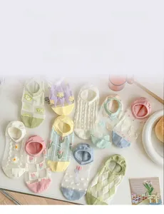 Close-up of assorted pastel mesh socks with floral embroidery and heart patterns