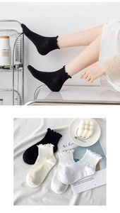 Detail of ruffle edge cotton socks in black, beige and white colors for women