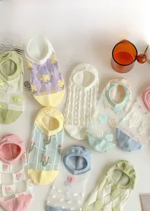 Flat lay of sheer mesh socks with floral tulip embroidery and colorful cotton toe detail