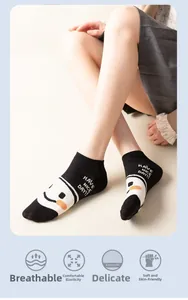 Detail of cotton crew socks with happy face pattern and Have a nice day text knitting