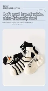 Close-up of black and white breathable cotton socks with cute smiley faces and stripes