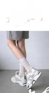 Detail of purple plaid women's mid-calf socks with ribbed cuffs and soft knit texture