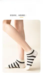 Close-up of white cotton ankle socks with black stripes on female model legs