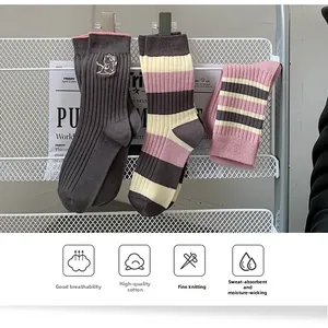 Close-up of breathable cotton socks featuring cute cartoon embroidery and stripe details