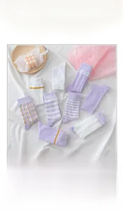 Detail of purple striped and checkered cotton socks with varied knit textures