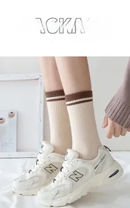 Detail of striped crew socks featuring a high-elastic cuff for a secure and comfortable fit