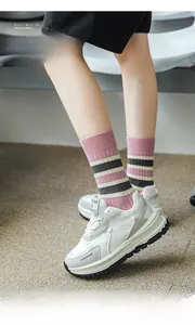 Pink and black striped cotton socks shown with white retro platform sneakers