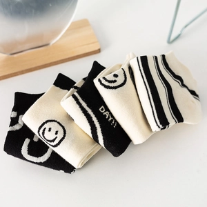Five pack of black and white striped cotton socks with smiley face and DAY text patterns