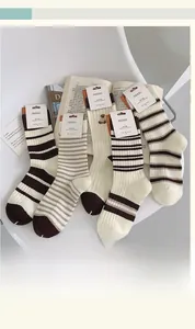 Detail view of cotton mid-calf socks with brown stripes and cute bear embroidery set