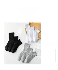 Detail of ribbed cuffs on white, black, and grey combed cotton socks set for couples