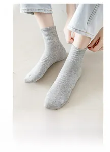 Close-up of gray cotton knitted mid-tube socks showing texture and soft material detail