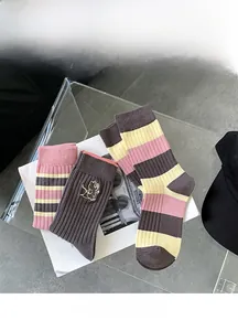 Detail of bamboo cotton striped socks with delicate cartoon embroidery and ribbed texture