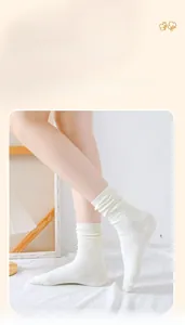 Detail of white cotton ribbed crew socks showing elastic texture and soft fabric