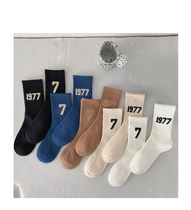 Flat lay of vintage style cotton crew socks in multiple colors with 1977 jacquard details