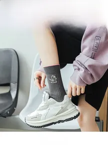 Detail of grey ribbed cotton socks with pink trim and cute white cat cartoon embroidery