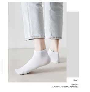 Close-up of white combed cotton crew socks with ribbed cuffs and arch support design