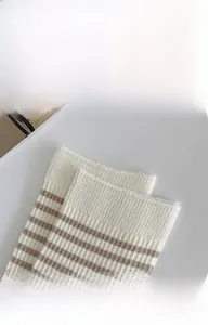 Detailed close-up of brown striped cotton socks featuring elastic ribbed cuffs and soft texture