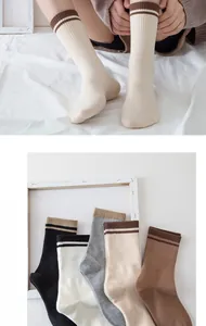 Detail showing various colors of striped mid-calf cotton socks with elastic ribbed texture