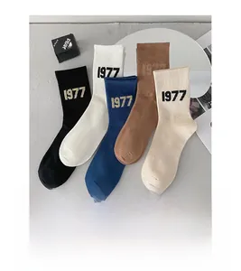 Detail of five-color knit mid-calf socks with 1977 embroidery and ribbed cuffs
