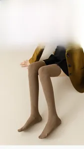 Detailed knit texture of coffee brown over-knee high socks in a winter outfit