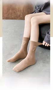 Detail of knitted crew sock in earth tone featuring a number 7 pattern and ribbed texture