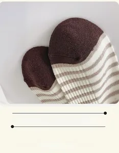 Detail of smooth toe seam on brown striped cotton crew socks with knit texture