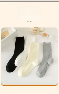 Pack of 4 women's cotton crew socks in black, white, beige and grey with ribbed texture