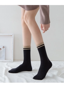 Detail of cotton crew socks showing black striped ribbing and breathable knit texture