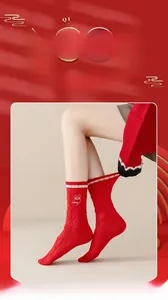 Detail of red cotton socks with diamond knit texture, striped cuffs, and rabbit logo