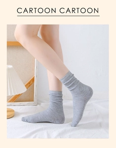 Detailed macro view of grey ribbed mid-calf cotton socks with soft indoor lighting texture