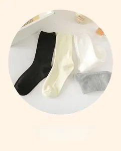 Vertical ribbed cotton mid-calf socks in black, cream, white, and grey color set