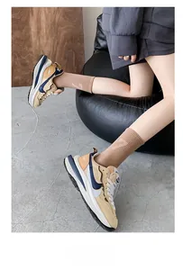 Close-up of vintage multi-color sneakers with layered soles and beige knit crew socks