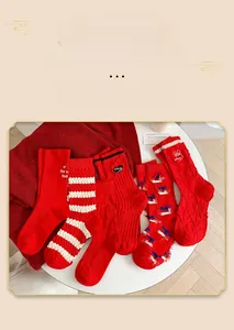 Detailed set of five red cotton mid-calf socks with various patterns and textures