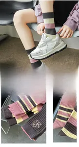 Close-up of pink striped bamboo cotton socks with cute animal embroidery and ribbed texture