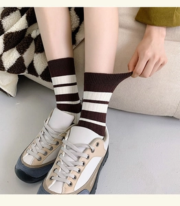 Detail of striped knitted socks showing high elasticity and soft ribbed cuff stretching