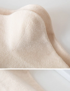 Close-up of beige cotton socks showing detailed knit texture and reinforced stitching
