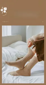 Close-up of retro camel wool blend socks with thick diamond knit texture and ribbed cuffs