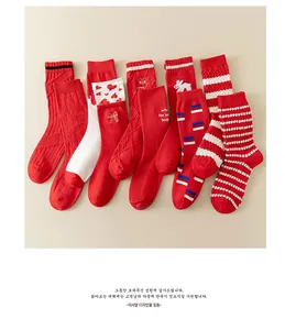 Detailed close-up of red cotton mid-calf socks with heart and rabbit embroidery motifs