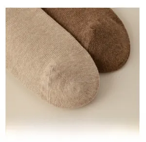 Macro detail of reinforced toe stitching on khaki and brown cotton over-knee socks