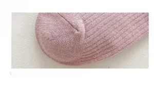 Detail view of pink cotton socks showing seamless toe stitching and ribbed knit texture