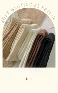 Close-up of thick knit crew socks in earthy tones showing soft texture and ribbed patterns