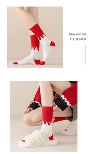 Detail of red and white cotton socks featuring unique artistic liquid drip patterns