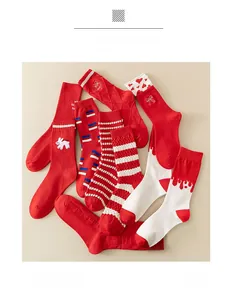 Flat lay of red cotton crew socks with various patterns like stripes and heart prints