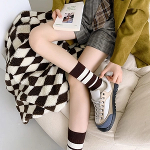 Retro color-block sneakers styled with brown striped bear embroidery crew socks