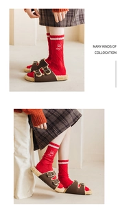 Detail view of red cotton mid-calf socks with white bunny print and knit texture