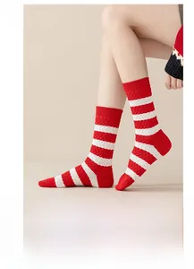 Detail view of red and white striped cotton socks with textured diamond pattern