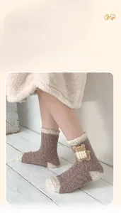 Gros plan sur des chaussettes en polaire corail avec ornement ours 3D et couleurs contrastées