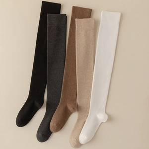 Five pairs of high-thigh over-knee socks in black, grey, and earth tones with ribbed cuffs